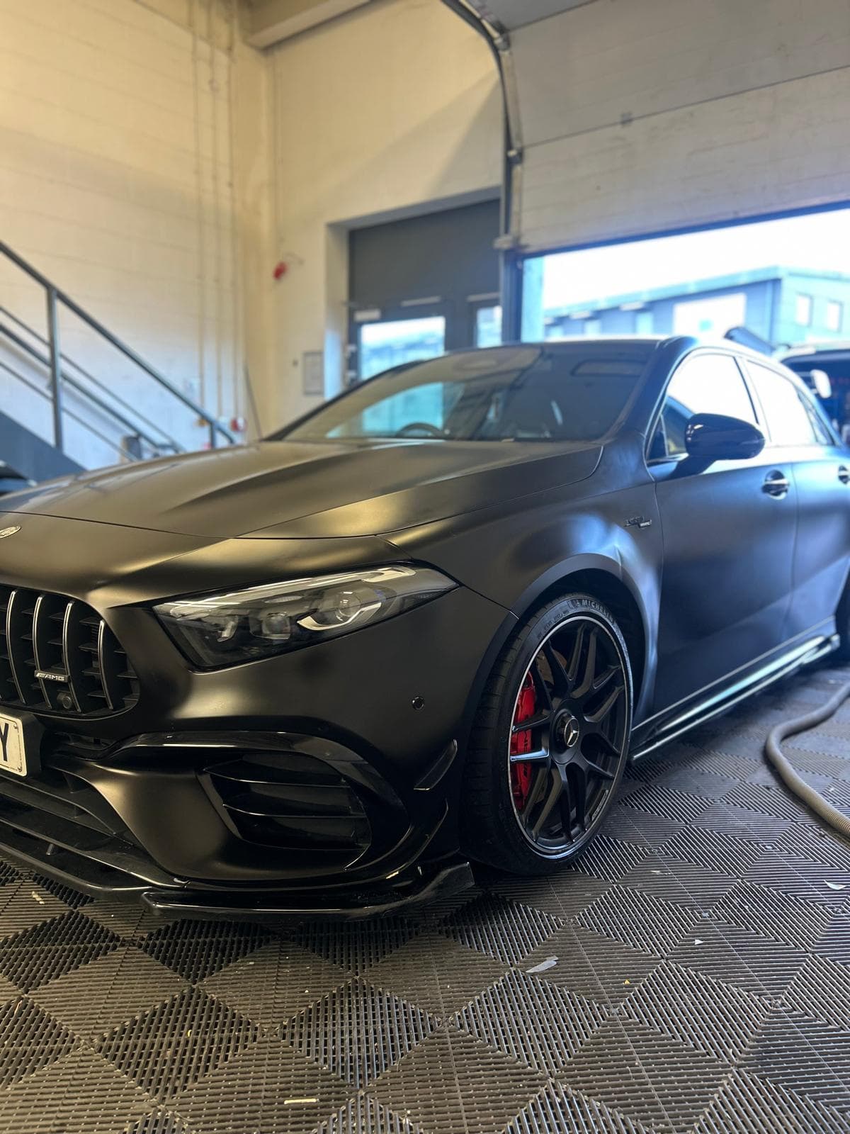 Matte black Mercedes AMG A45 in detail garage